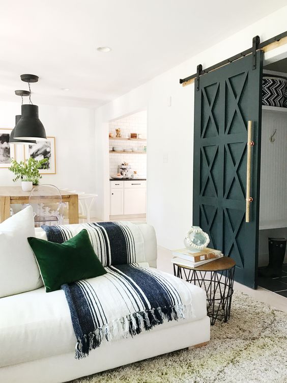 paint the barn door black and add a gold handle to make it look more glam-like and chic