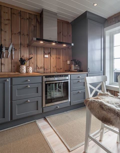 graphite grey vintage looking cabinets are softened and warmed up with light colored wood
