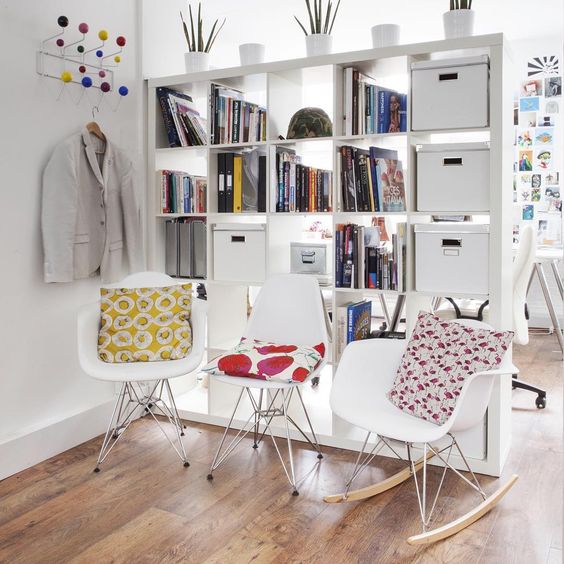 IKEA Kallax shelving unit hides a home office nook from the entryway and boxes inserted bring more privacy