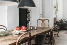 23 a rustic antique table and a mix of rustic and modern chairs of metal, wood and leather