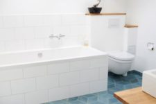 23 large white tiles for a backsplash and to cover the bathtub for a unified and chic look
