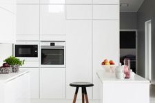 24 a high gloss white kitchen with tall wall cabinets and an island