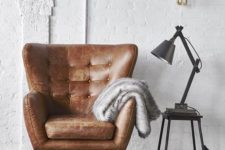 24 create a stylish reading nook with a leather wingback chair and an industrial lamp