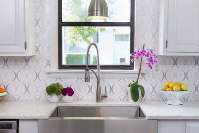 wallpaper isn't expensive and you can refresh and change the kitchen look changing the wallpaper backsplash