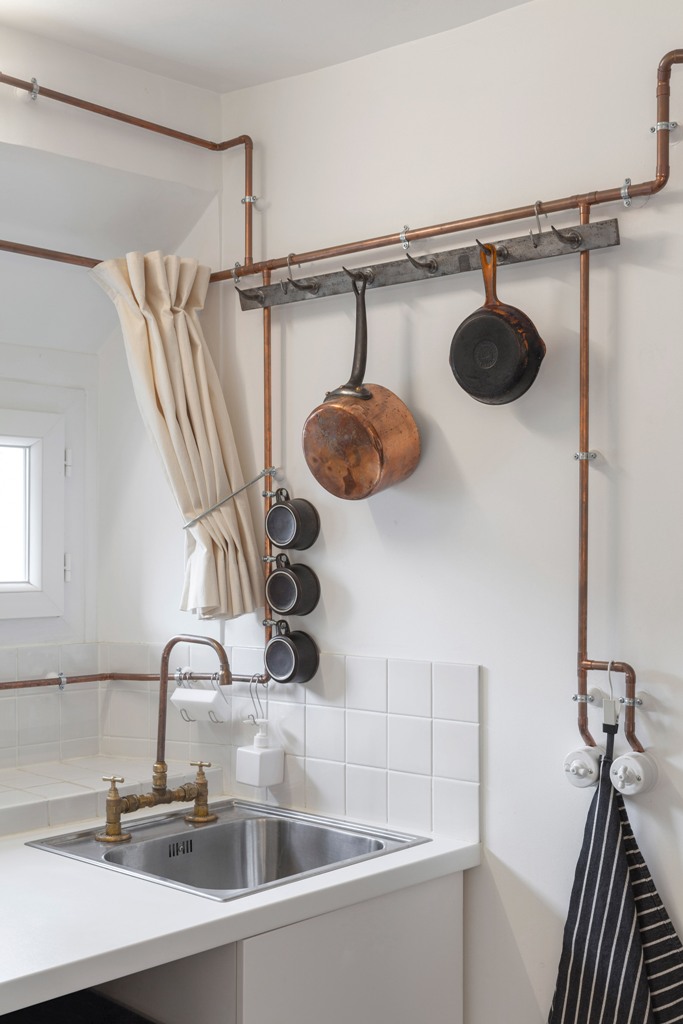 The whole apartment is done in white, and the main feature is copper pipes that are shown in the whole apartment and serve various purposes The whole apartment is done in white, and the main feature is copper pipes that are shown in the whole apartment and serve various purposes