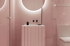 02 a minimalist light pink bathroom with black touches for depth and a mirror with built-in lights