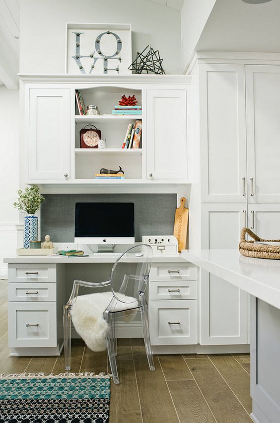 a seamlessly built-in office nook in the kitchen, the desk and cabinets made in the same style and look as the kitchen itself