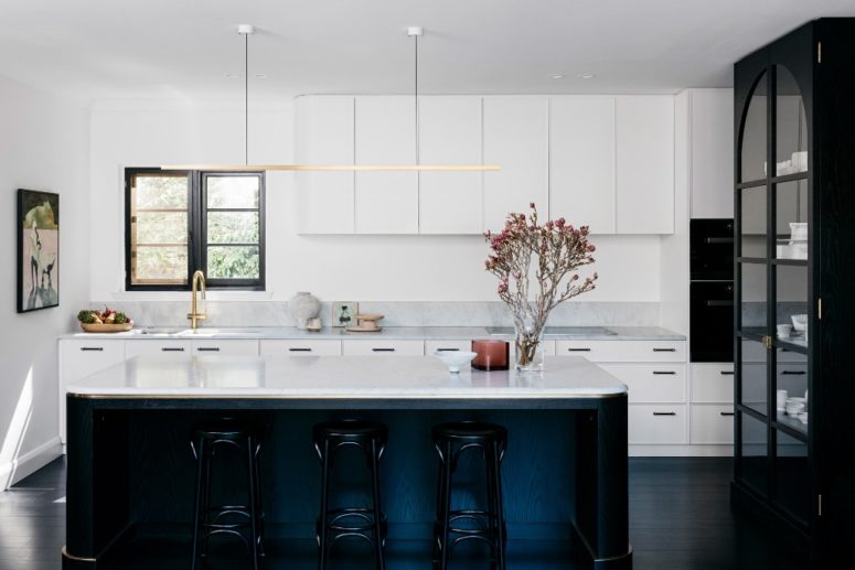 black and white kitchen in modern style the kitchen features amazing white cabinets and surfaces spruced up with gilded touches and given depth with black details