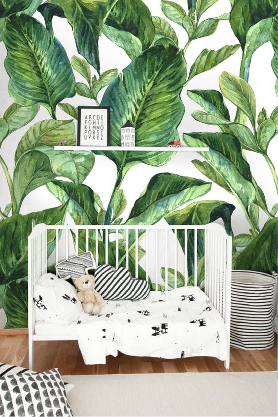 a cool nursery with a banana leaf print wall and all the rest done in black and white for a contrast