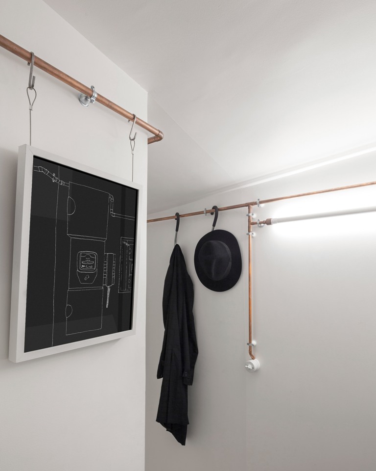 Copper pipes serve as an open closet and even hold outlets and I think that they give the apartment its own character