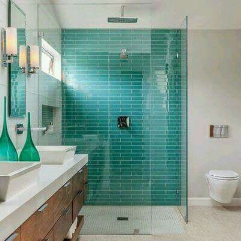 a contemporary bathroom with a turquoise tile statement wall in the shower for a wow effect