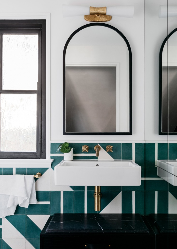 bathroom with geometric tiles on walls The bathroom is done with amazing green geometric tiles, black marble touches and brass fixtures