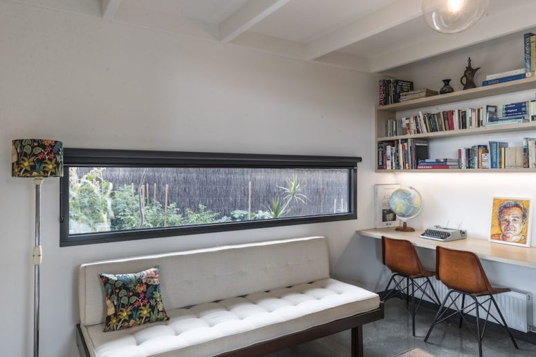 minimalist home office with a long window The home office is done with a long narrow window, a shared office space and an upholstered bench