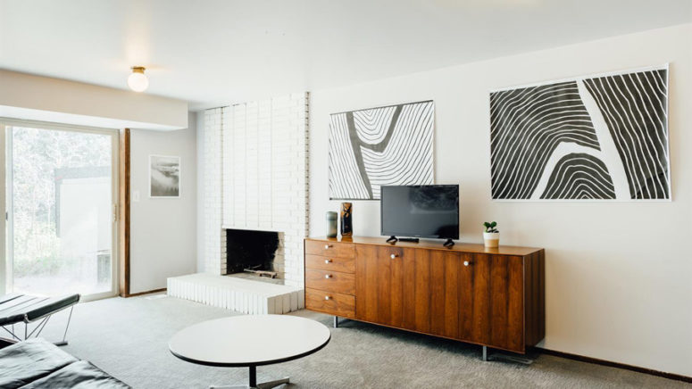 living zone with some cool funriture Here's another sitting zone with a brick clad fireplace, monochrome artworks and cool furniture