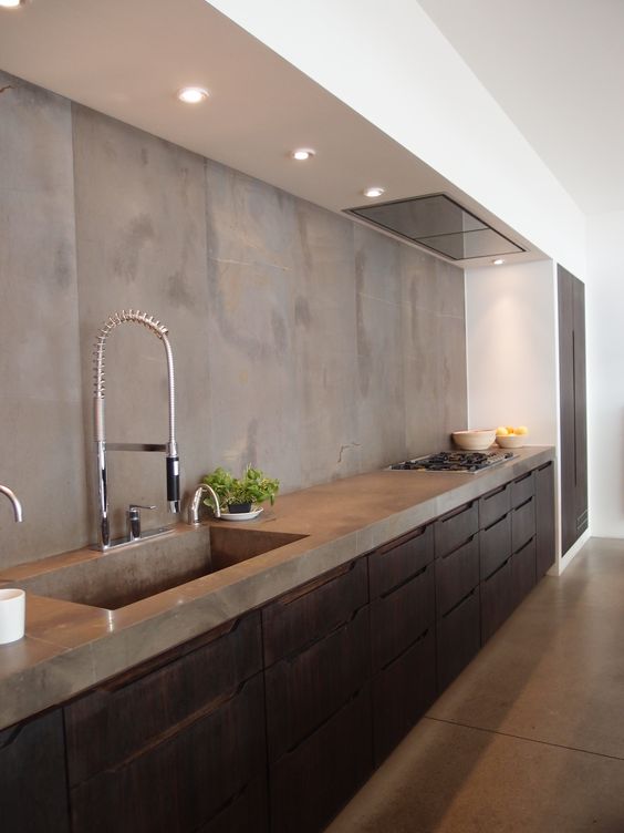 dark-stained wooden cabinets with a concrete backsplash and countertops for a textural and catchy look