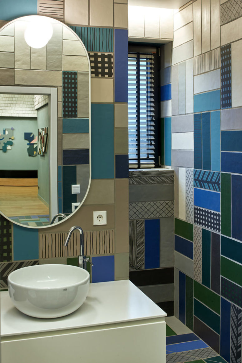 bold tiled bathroom The bathroom is clad with colorful mosaic tiles that remind of the repeated patterns throught the house