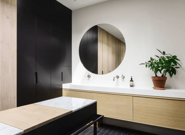 black and white bathroom design The bathroom is done in black and white with light-colored wood and marble for a chic look