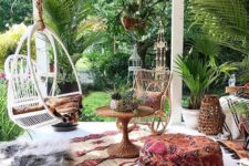 08 a boho porch with printed and colorful textiles, woven lanterns and baskets, rattan furniture and potted greenery