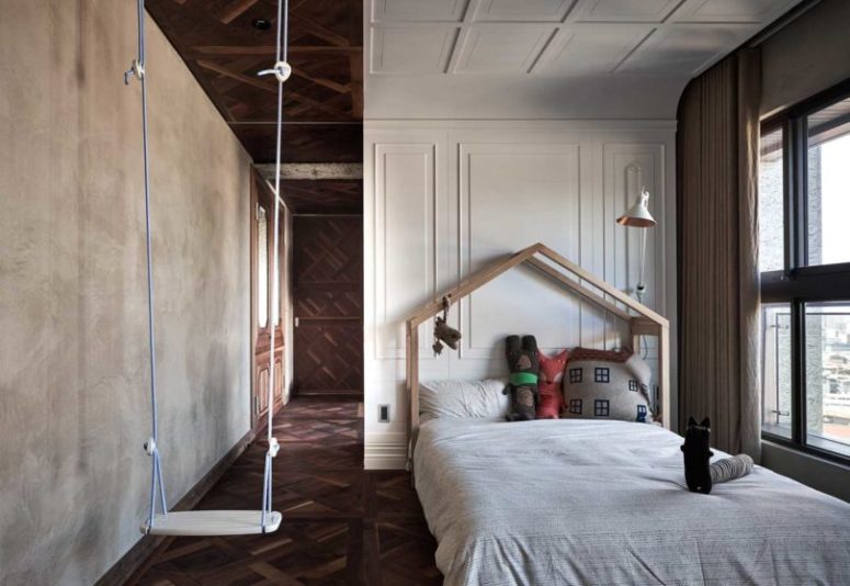 swings in a kids room The kids' room is done with a swing, a house-shaped bed and concrete and molding walls