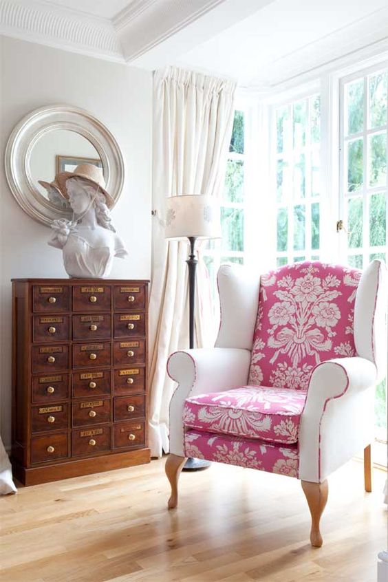 a chic vintage chair is made more modern with a pink printed seat and back and white armrests