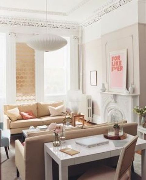 a white desk doesn't attract much attention behind the sofa and is enough for a home office