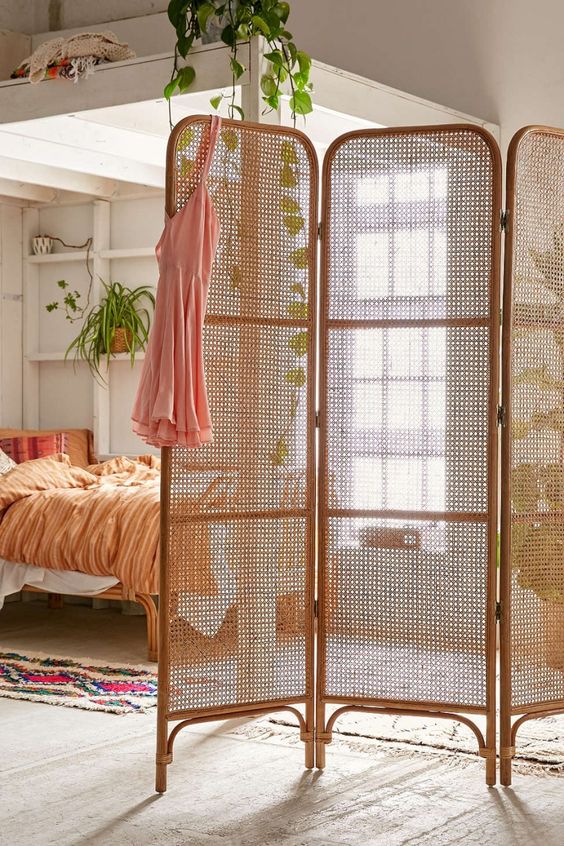 an elegant rattan and wood lettice screen is great to separate some space of your home without a bulky look
