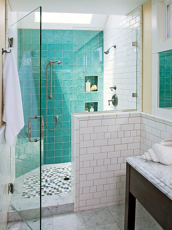 glossy turquoise tiles covering the shower wall add color to the bathroom and spruce it up