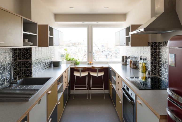 kitchen with tiles on a backsplash The kitchen is done in grey, yellow, white and patterned tile backsplashes, the breakfast space is on the windowsill