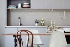 10 a monochrome grey kitchen is perfectly completed with a raw concrete backsplash that makes it cooler