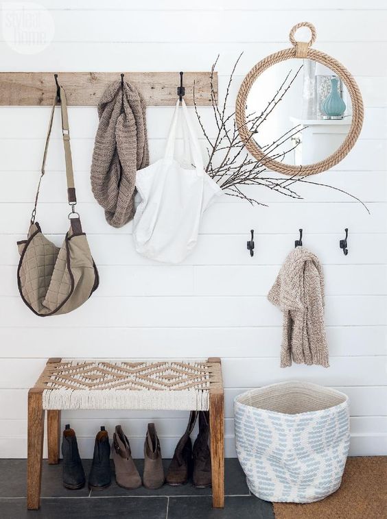 a wooden rack, a rope mirror, a basket for storage, a woven bench for a serene boho look