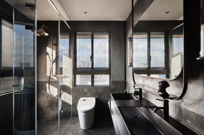 industrial bathroom The bathroom is done in more industrial style, with grey tiles and metal sinks