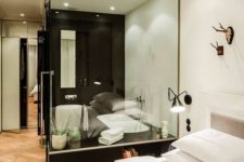 11 a black and white contemporary bedroom with a bathtub in a glass cube to integrate it into the decor