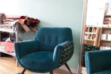11 a cool rounded chair with teal upholstery and a printed curved base to make it stand out