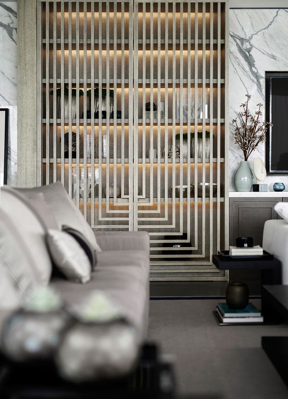 a built-in storage unit covered with a wood lettice screen and with inner lights for a modern space