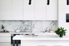 12 a monochromatic space in black and white with a white marble backsplash and black lights for a deeper look