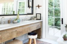 12 a rough wooden vanity, baskets and some potted plants plus a boho rug make the space boho chic
