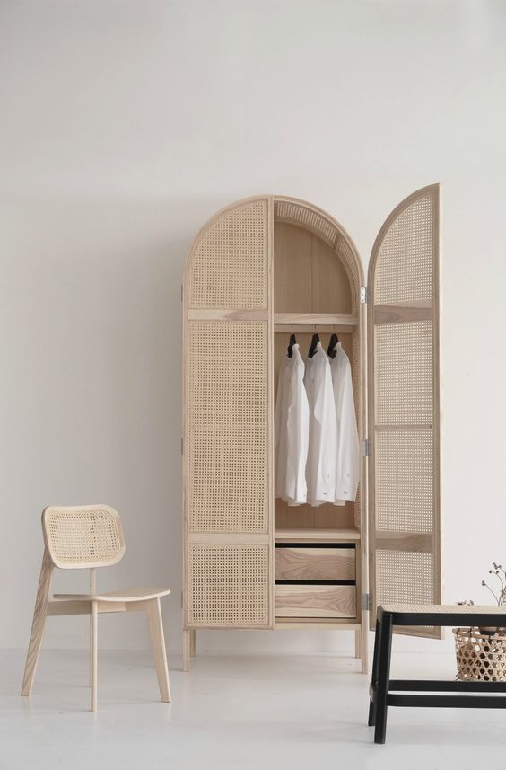 a chic dresser with wood lattice doors brings a coastal feel to the space and looks very airy