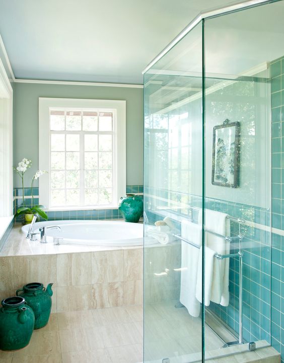 a turquoise tile wall and matching decorative vases to match the look and add colro to the space