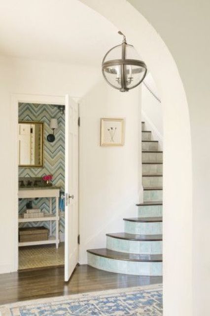 eye-catchy geometric wallpaper, an elegant mirror to make your powder room cooler