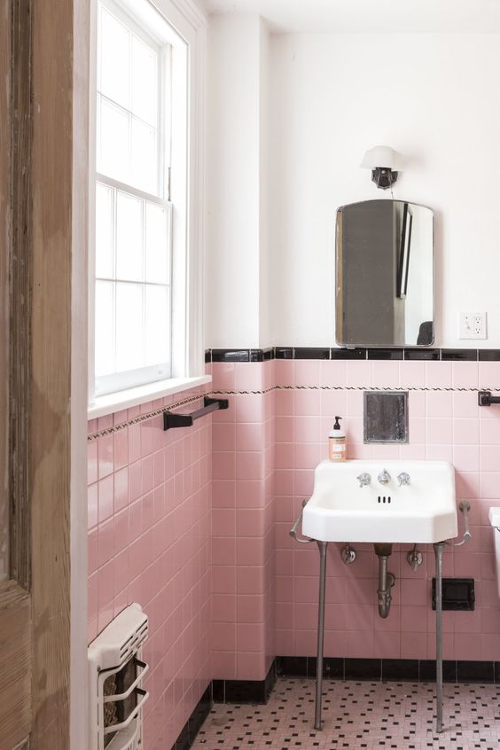 pink tiles with a black tile trim create a glam and girlish space and a white part makes it brighter