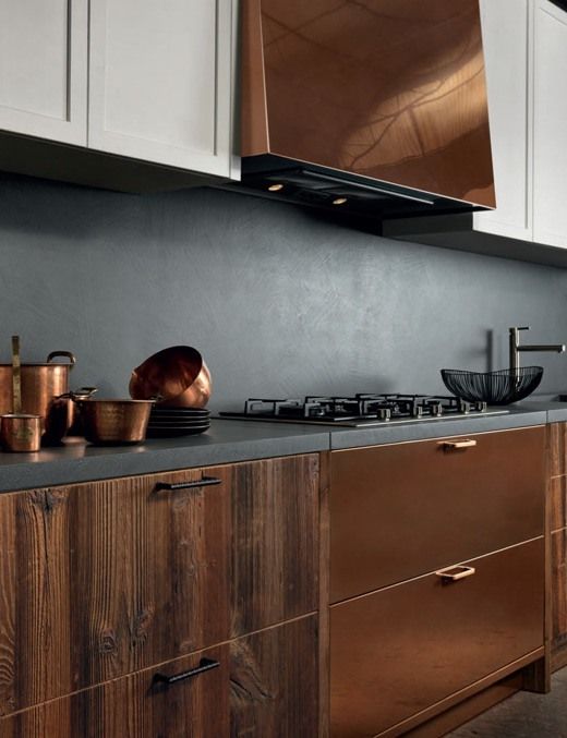 stained wood, copper and white kitchen cabinets calmed down with a grey concrete backsplash and countertops