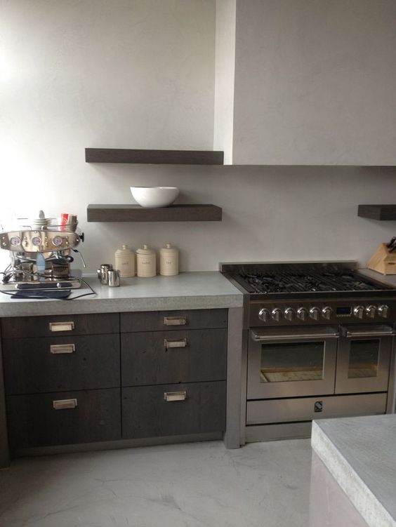 light-colored creamy concrete countertops and a backsplash for a contrast with dark stained cabinets