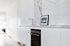 16 a minimalist white kitchen with a white marble tile backsplash and touches of grey for a chic look