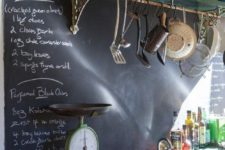 16 a vintage space with dark shabby shelves and countertops and a chalkboard backsplash