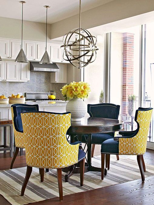 wingback chairs with cutout backs, navy upholstery with a nail trim and bold yellow print backs