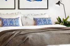 17 a textural bedspread, pritned pillows and bold blue artworks over the bed refresh the neutral space