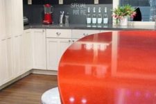17 a white kitchen, a chalkboard backsplash and a red dining table for a bold look