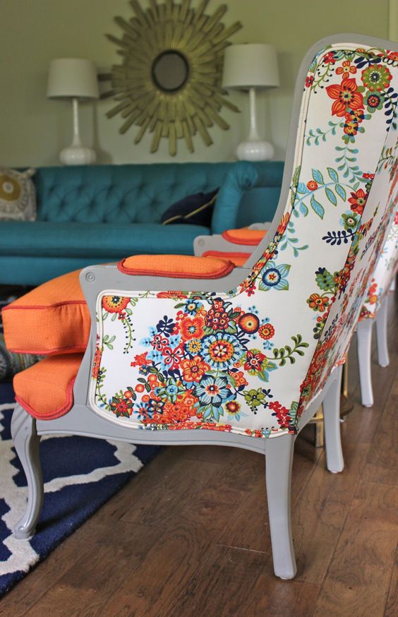 bold orange chairs with floral print backs look vintage and modenr at the same time