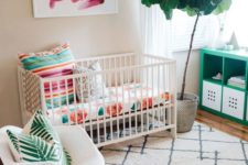 18 a colorful tropical-inspried nursery with floral, palm prints, potted greenery and artworks