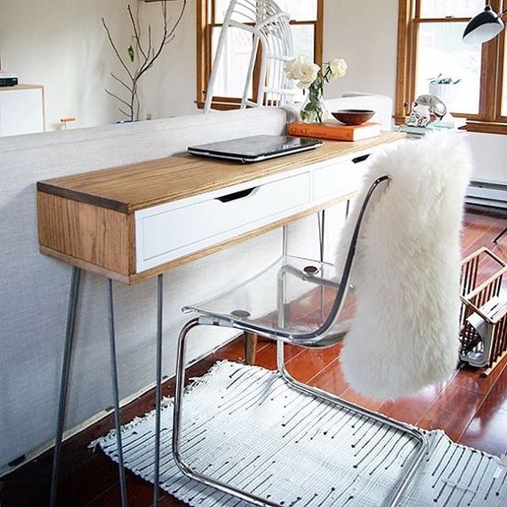 a comfy narrow mid-century modern desk plus an acrylic chair is ideal for a modern living room